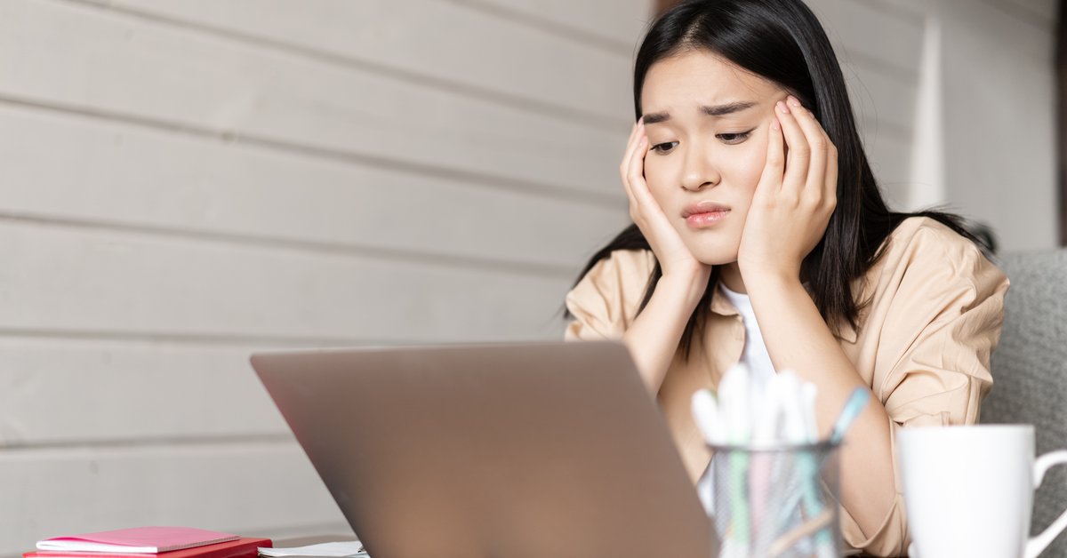 Employee taking online course training on laptop in modern office